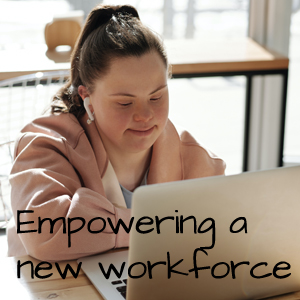 Empowering a new work force, a woman sits looking at the screen of her computer.