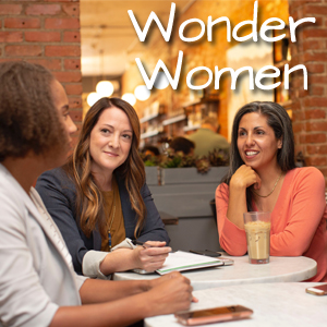 Wonder Women, three women talk around a table
