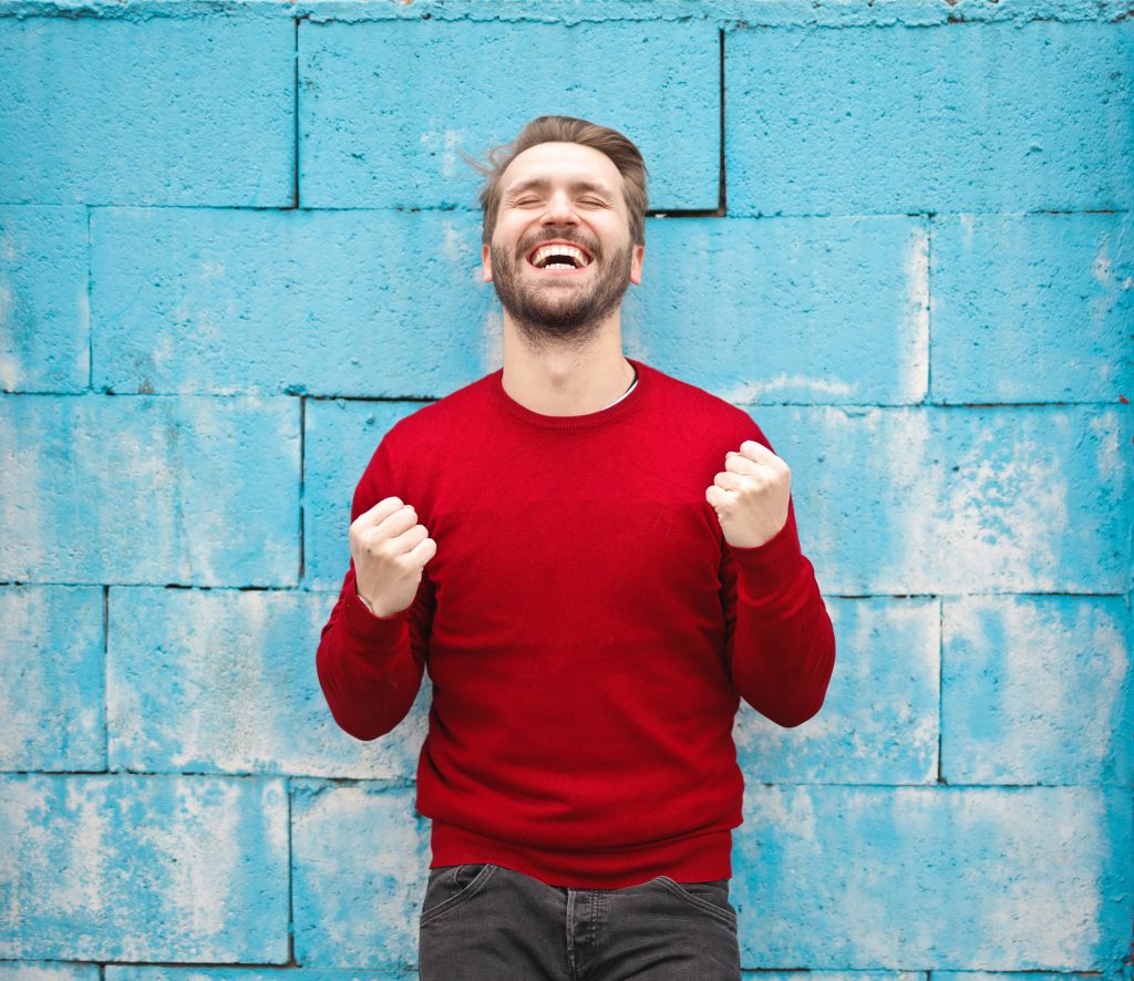 A man gleefully cheers