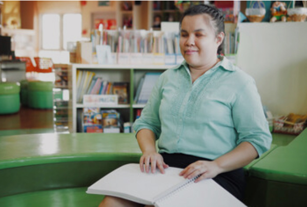 Woman reading braille