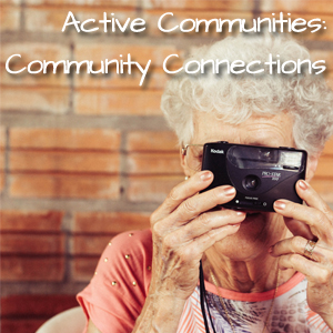 Active Communities: Community Connections. An elderly woman looks in at the back of a camera ready to take a photo.