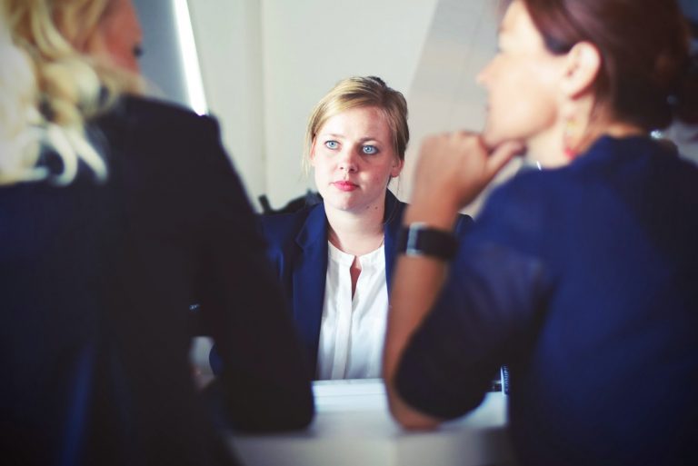 three business women sit down to discuss.